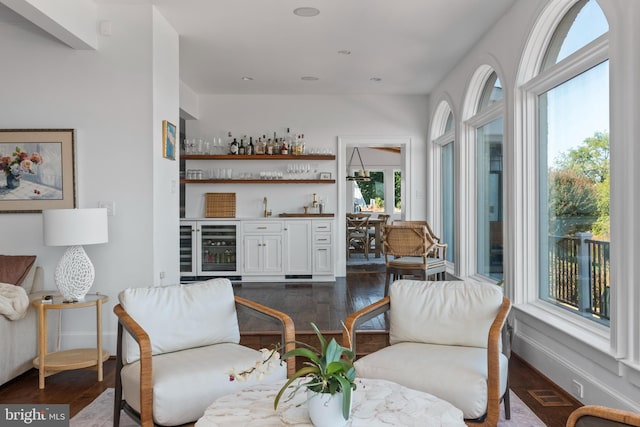 803 Coachway, Annapolis, MD 21401 - living area featuring visible vents, baseboards, wine cooler, a dry bar, and dark wood-style floors