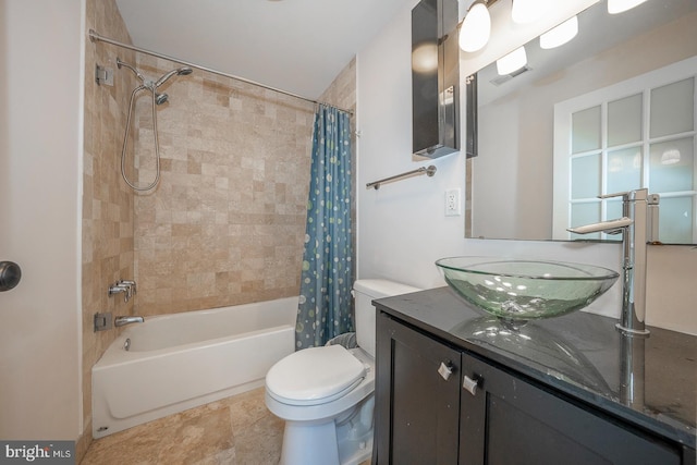 full bathroom featuring toilet, shower / tub combo with curtain, and vanity