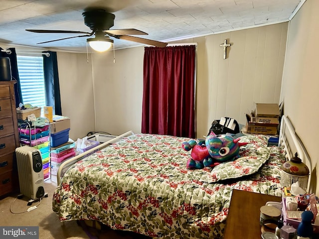 bedroom featuring ceiling fan and carpet