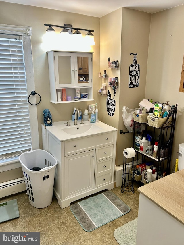 bathroom with vanity and baseboard heating