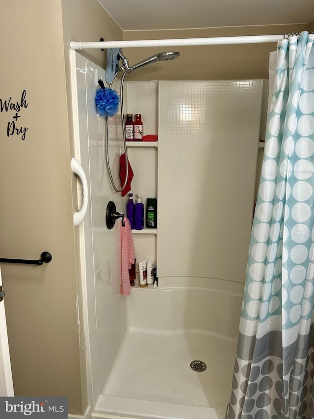 bathroom with a shower with shower curtain