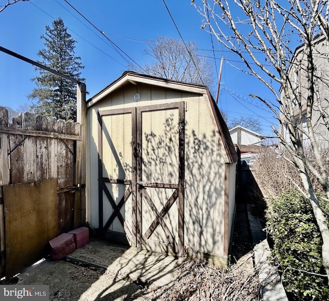 view of shed with fence