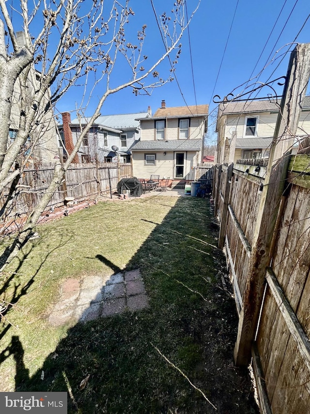 view of yard featuring a patio area and a fenced backyard