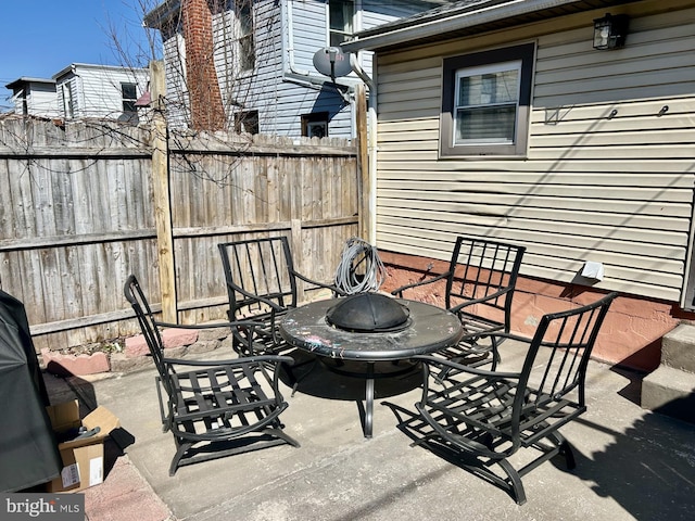 view of patio / terrace featuring an outdoor fire pit and fence