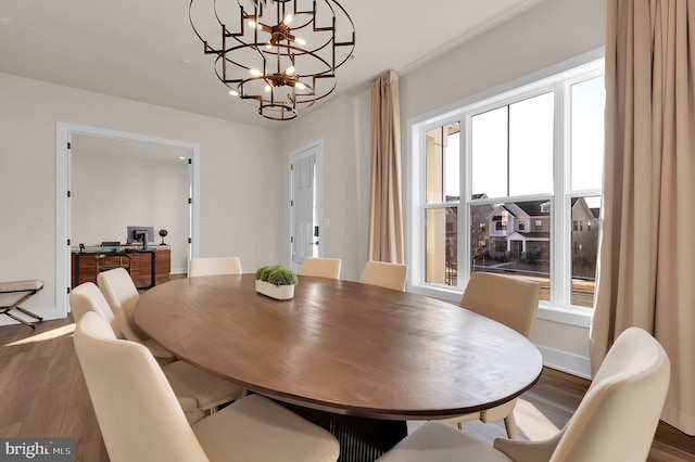 dining room with baseboards and wood finished floors