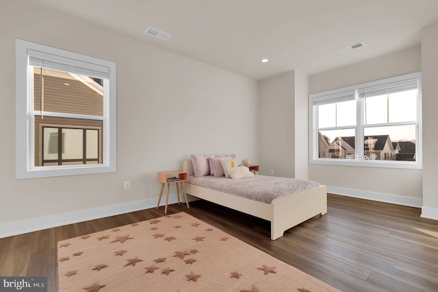 bedroom featuring recessed lighting, visible vents, baseboards, and dark wood finished floors