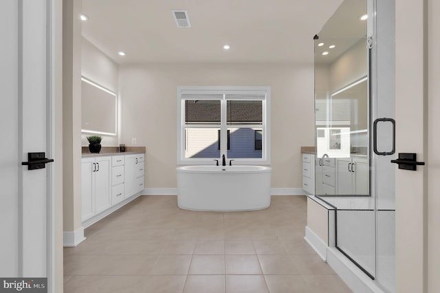 full bathroom with visible vents, a shower stall, recessed lighting, a soaking tub, and vanity