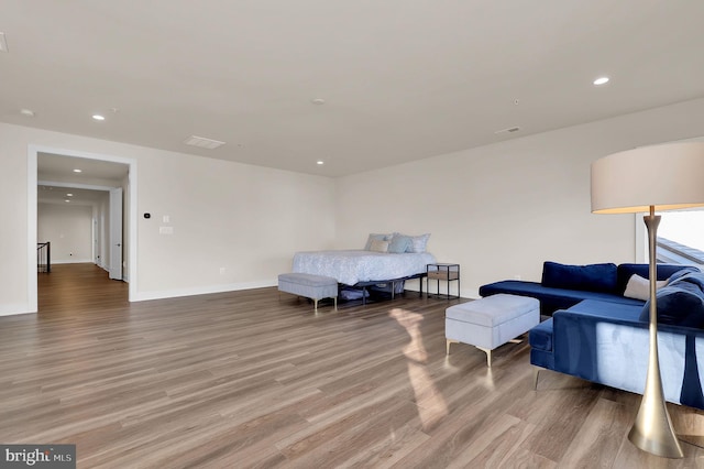 bedroom with recessed lighting, light wood-style floors, visible vents, and baseboards