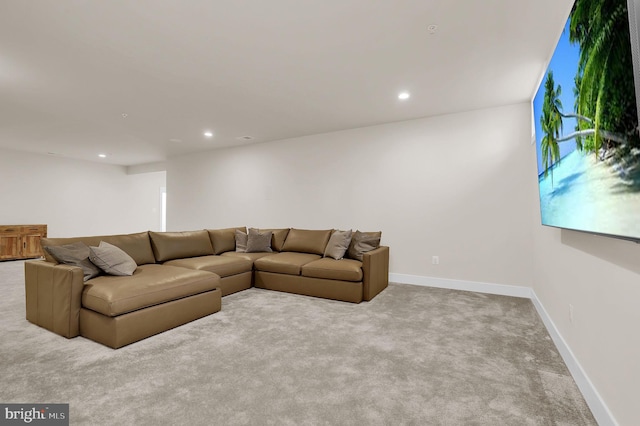 carpeted living area featuring recessed lighting and baseboards