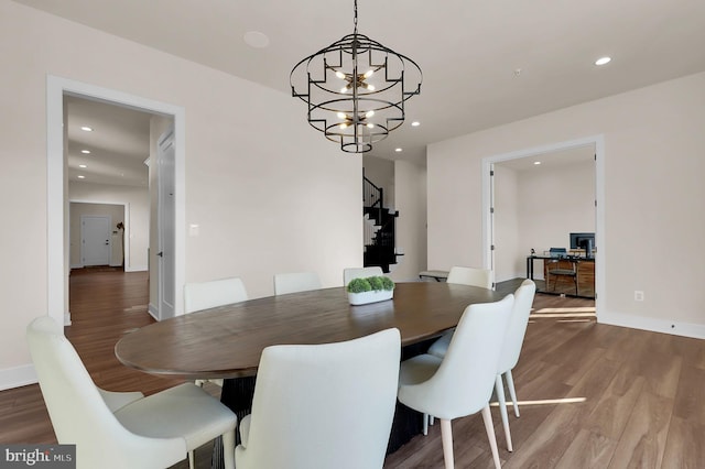 dining space with recessed lighting, wood finished floors, baseboards, and a chandelier