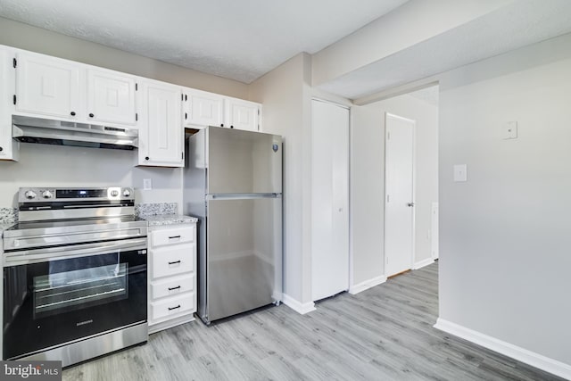 kitchen featuring stainless steel appliances, white cabinets, light wood-style floors, and under cabinet range hood