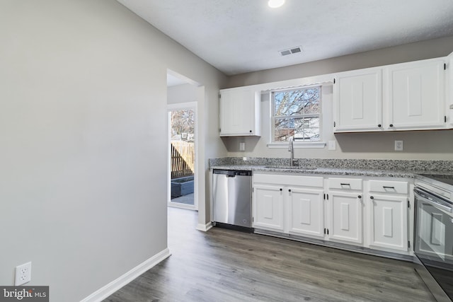 kitchen featuring white cabinets, visible vents, stainless steel appliances, and a sink