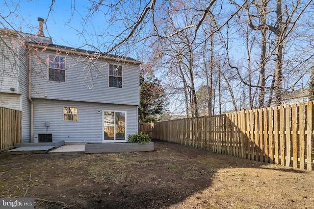 back of property with a patio area and a fenced backyard