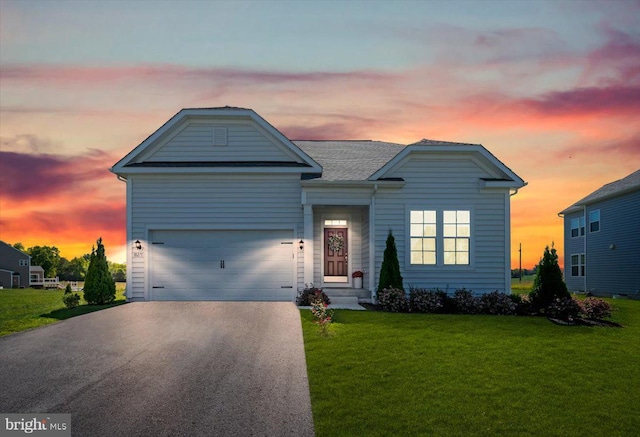 view of front of house with a garage, driveway, and a front yard