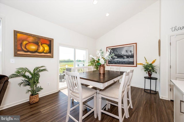 dining area with vaulted ceiling, dark wood-style flooring, and baseboards