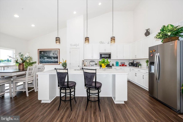 kitchen featuring white cabinetry, appliances with stainless steel finishes, light countertops, and dark wood-style flooring