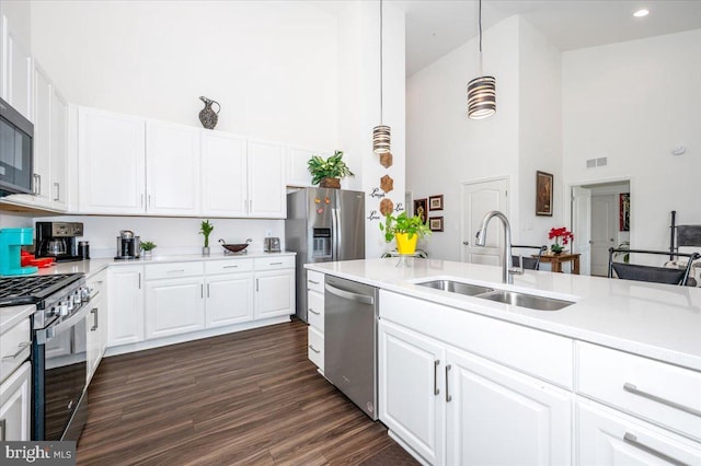 kitchen with light countertops, appliances with stainless steel finishes, a sink, and visible vents