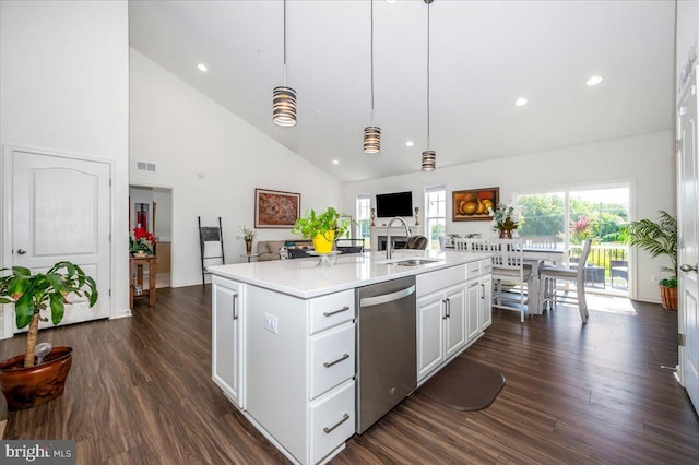 kitchen featuring light countertops, dark wood-type flooring, open floor plan, a sink, and dishwasher