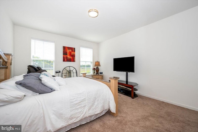 carpeted bedroom with baseboards