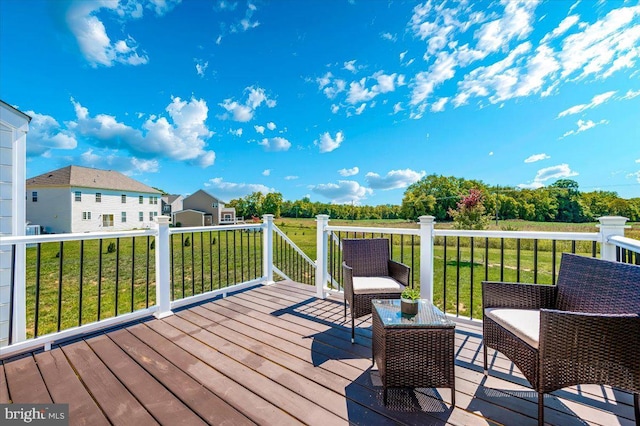 wooden deck featuring a lawn