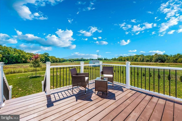 wooden terrace with a rural view and a yard