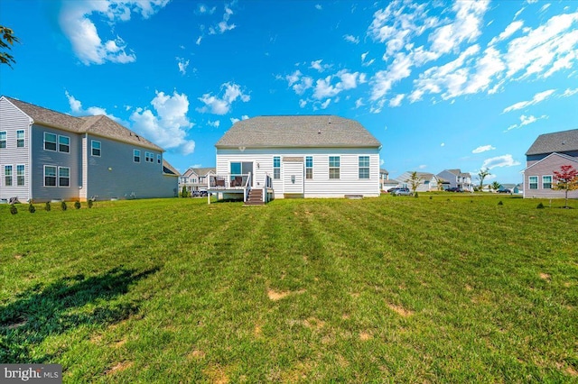 back of property with a yard and a residential view