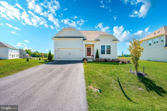 view of front of house featuring driveway, a garage, and a front lawn