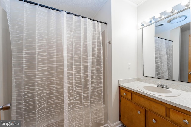 bathroom with a textured ceiling and vanity