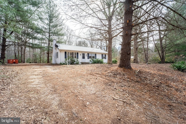 single story home featuring metal roof