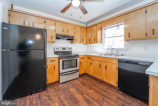 kitchen featuring dark wood finished floors, under cabinet range hood, light countertops, black appliances, and a sink