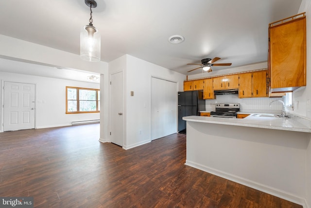 kitchen featuring stainless steel electric stove, a baseboard heating unit, freestanding refrigerator, a sink, and under cabinet range hood