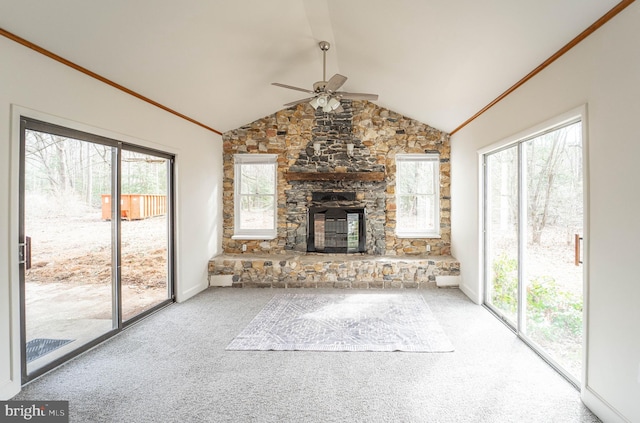 unfurnished living room featuring carpet, a fireplace, ornamental molding, and vaulted ceiling