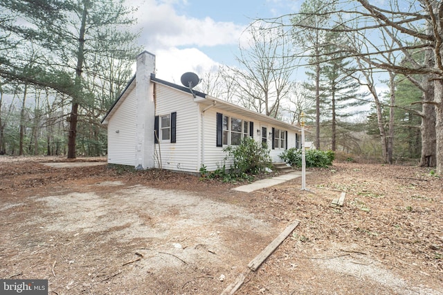 view of side of property featuring a chimney