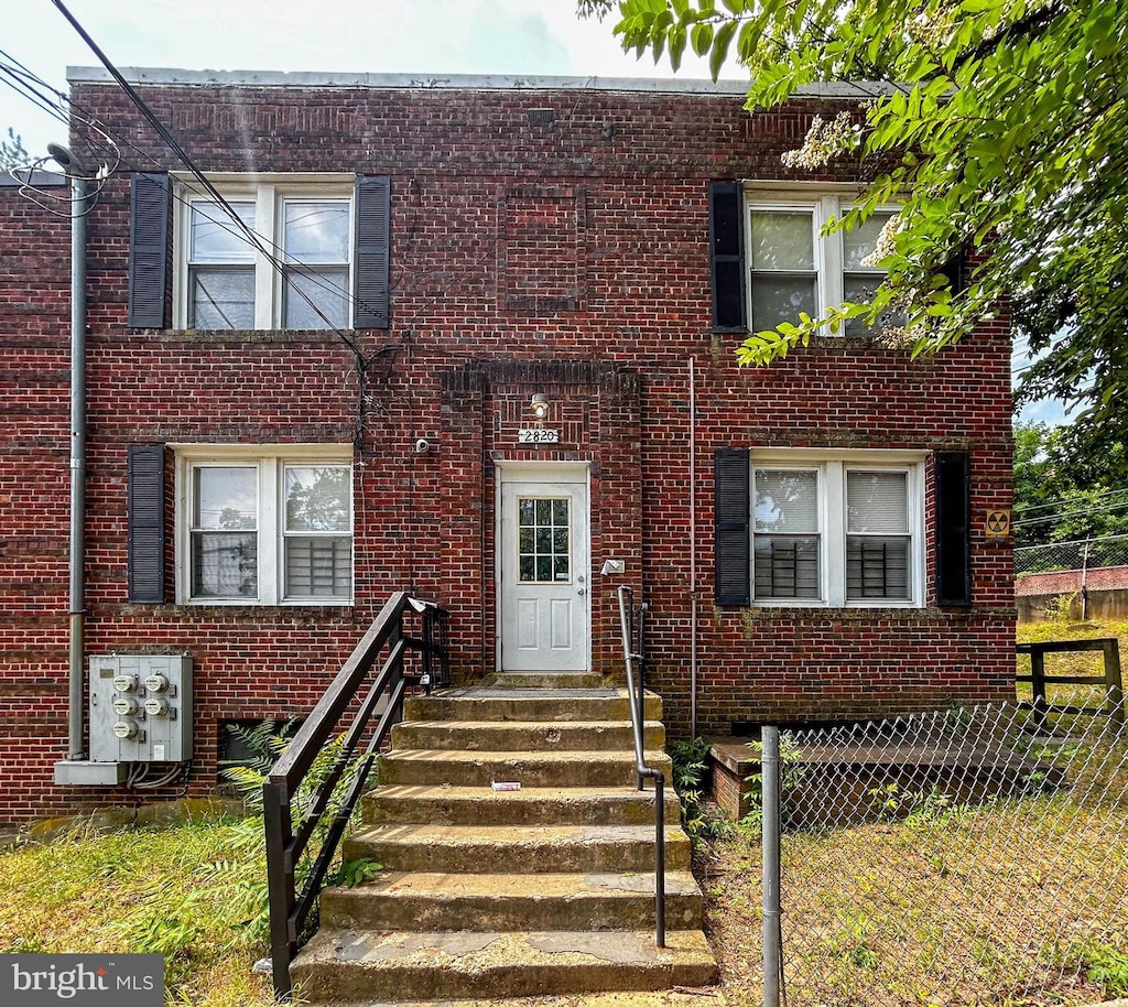 multi unit property with brick siding and fence