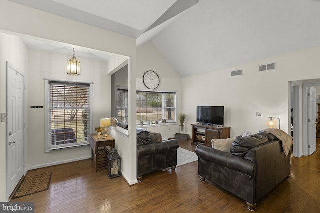 living area with high vaulted ceiling, visible vents, dark wood finished floors, and baseboards