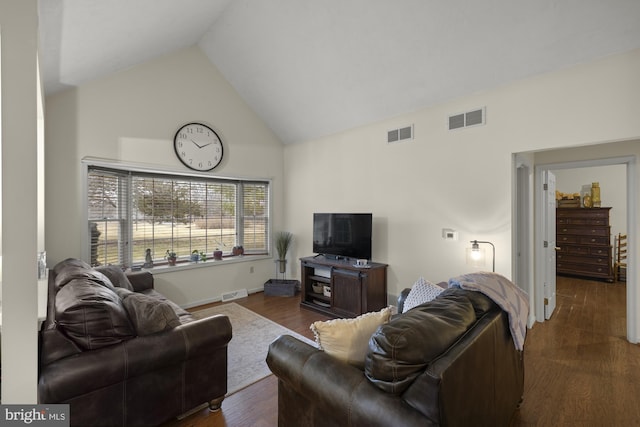 living area featuring high vaulted ceiling, visible vents, and dark wood-style flooring