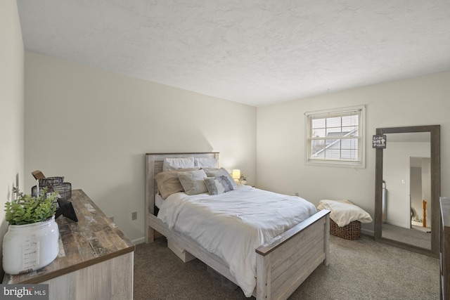 carpeted bedroom with baseboards and a textured ceiling