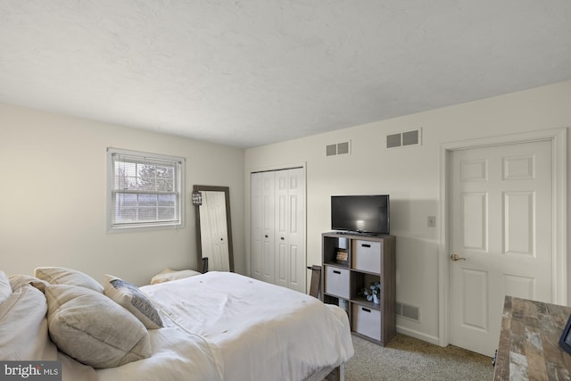 bedroom with light carpet, a closet, and visible vents