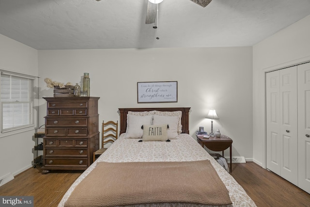 bedroom featuring a closet, wood finished floors, a ceiling fan, and baseboards