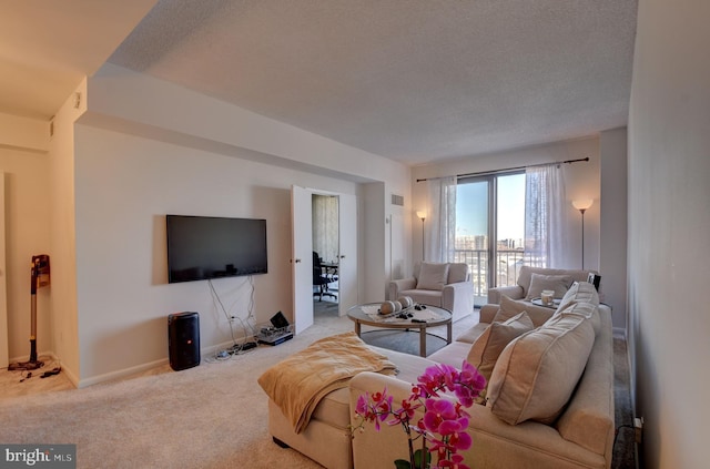 living area with visible vents, a textured ceiling, baseboards, and carpet floors