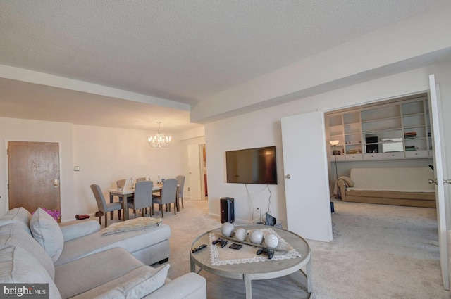 carpeted living area featuring a textured ceiling and a chandelier