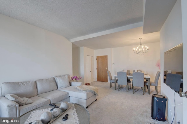 carpeted living room with a textured ceiling and a chandelier