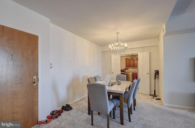 dining space with an inviting chandelier, light colored carpet, and baseboards