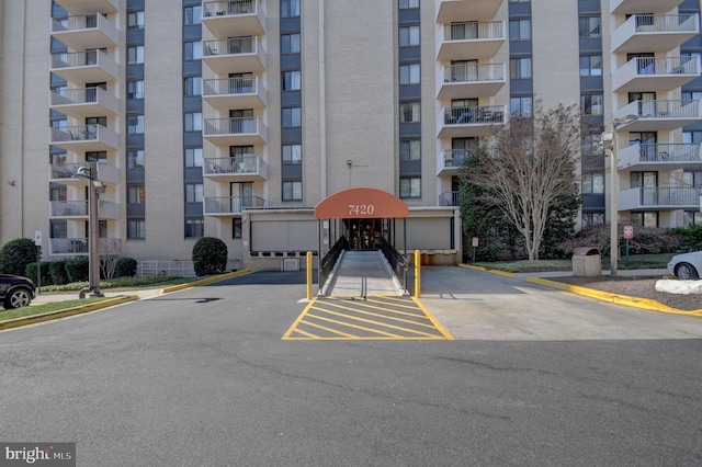 view of building exterior with uncovered parking