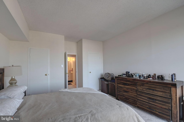 bedroom with carpet flooring and a textured ceiling