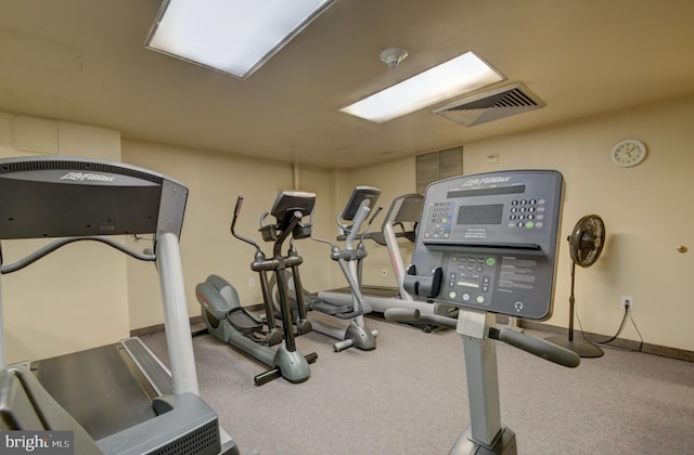 workout area featuring visible vents, baseboards, and carpet floors