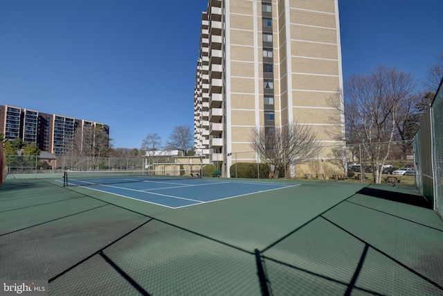 view of tennis court with fence