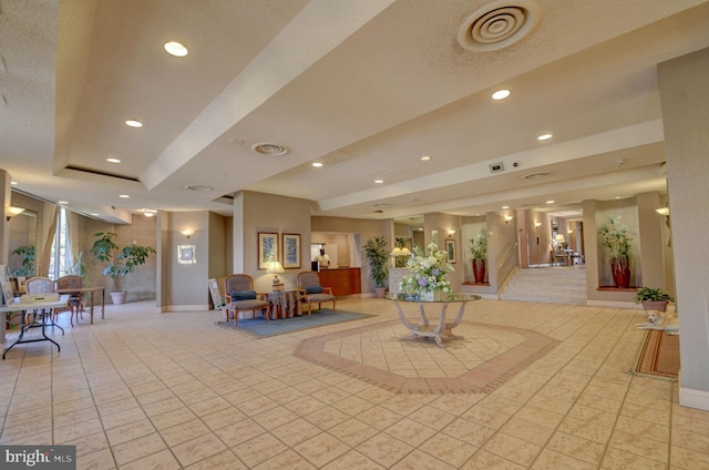 building lobby with stairs and visible vents