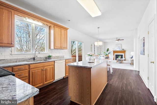 kitchen with a kitchen island, dark wood-type flooring, dishwasher, decorative backsplash, and a sink