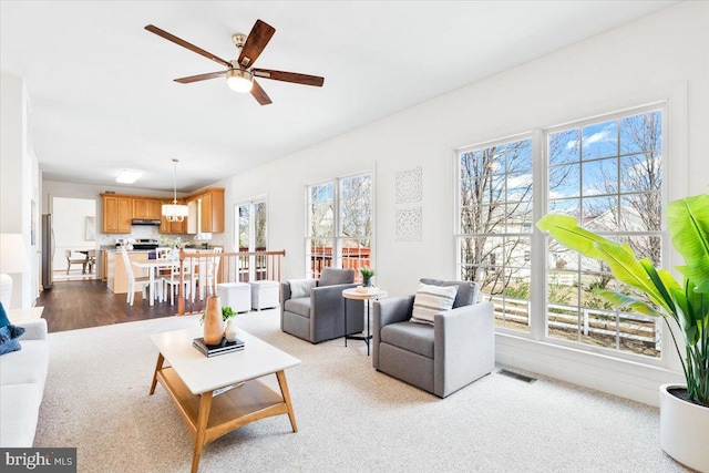 living room with visible vents and a ceiling fan